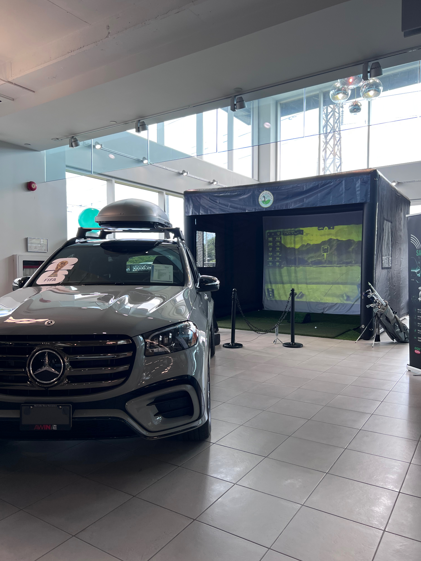 19th Hole Mobile simulator bay set up inside a Mercedes-Benz Toronto dealership showroom